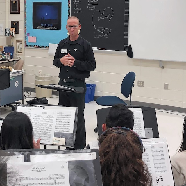 Saxophonist Chris Blossom leading a workshop with students.