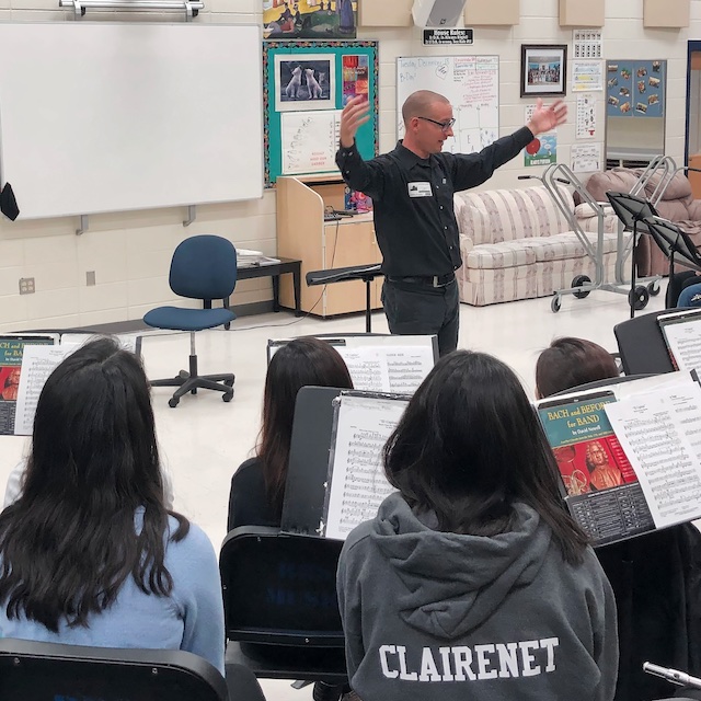 Saxophonist Chris Blossom leading a workshop with students.