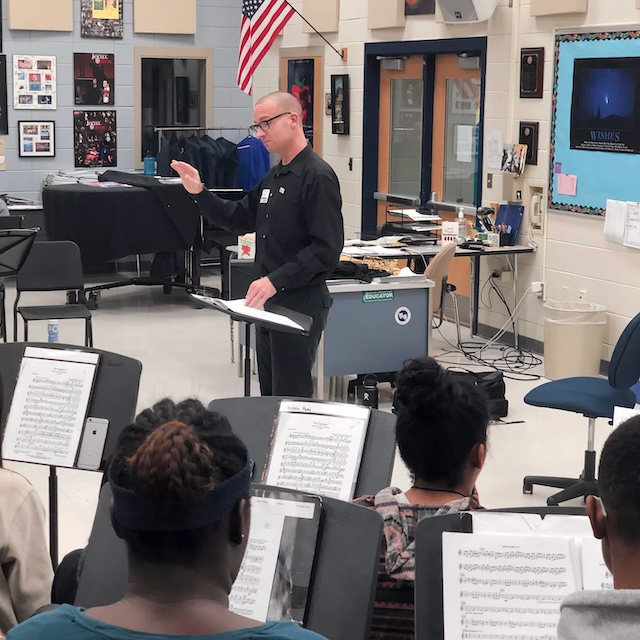 Saxophonist Chris Blossom leading a workshop with students.